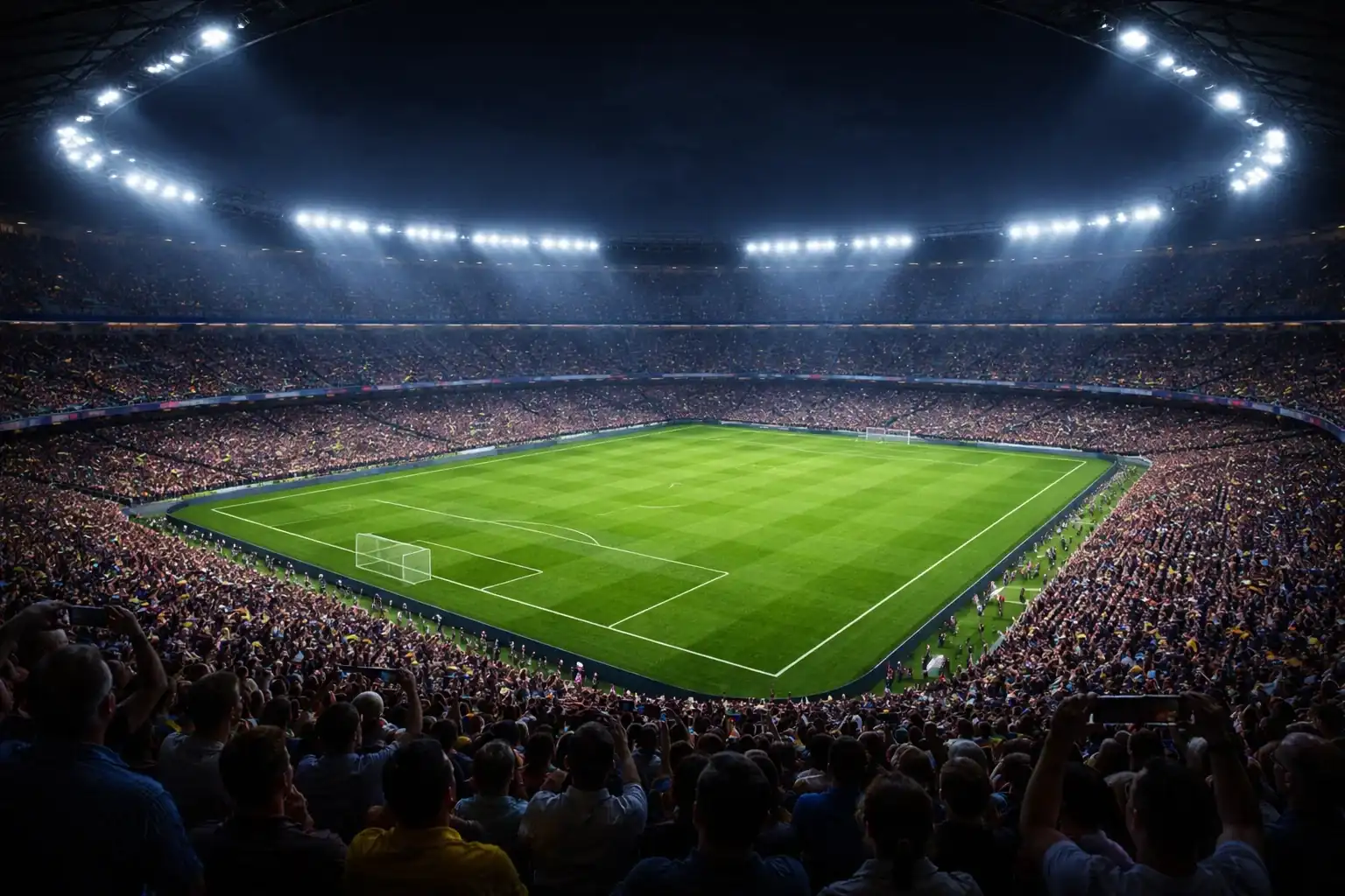 Estadio de fútbol iluminado durante un partido nocturno con aficionados en las gradas